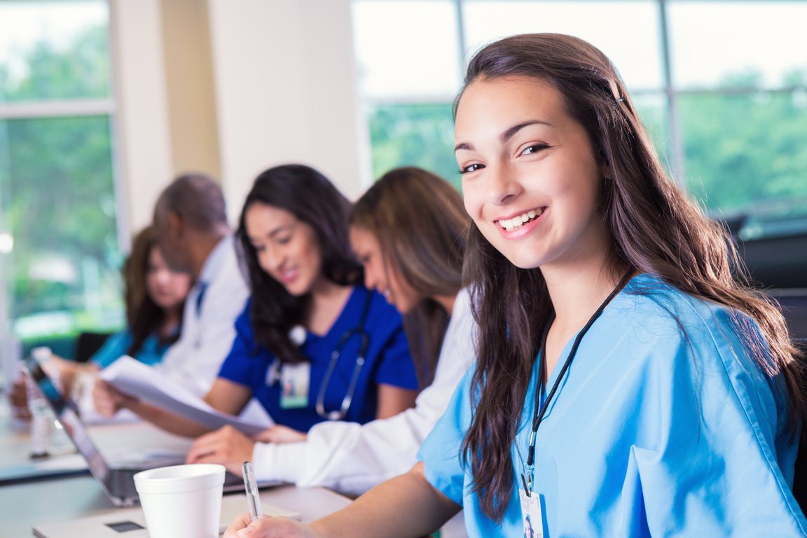 Young nursing student smiling while attending medical education class